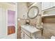 Elegant bathroom vanity featuring granite countertops and decorative mirror at 504 E Lee St, Plant City, FL 33563