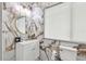 Elegant bathroom featuring marble-style tile, modern vanity, and a round mirror at 504 E Lee St, Plant City, FL 33563