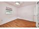 Bedroom with wood floors, a window, and a closet at 504 E Lee St, Plant City, FL 33563