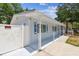 Side view of home featuring a clean, white exterior and well-maintained walkway at 504 E Lee St, Plant City, FL 33563