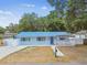 Charming single-story home with a vibrant blue roof and well-maintained landscaping at 504 E Lee St, Plant City, FL 33563