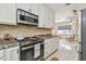 Functional kitchen featuring stainless steel appliances and elegant backsplash at 504 E Lee St, Plant City, FL 33563