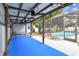 Covered patio includes ceiling fans, with view to the screened pool area, creating the perfect outdoor retreat at 504 E Lee St, Plant City, FL 33563