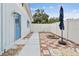 Enclosed patio with blue accent door, firepit, and white privacy fence creates a cozy outdoor space at 504 E Lee St, Plant City, FL 33563