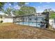 A screened pool area is surrounded by mature trees creating a backyard oasis at 504 E Lee St, Plant City, FL 33563