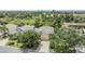 An aerial view showing the home's location with mature trees and backyard pond at 5205 Lansdowne Way, Palmetto, FL 34221