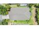 Aerial shot of a home with a well-maintained roof, green lawn, and screened-in patio at 5205 Lansdowne Way, Palmetto, FL 34221