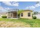 Well-maintained backyard featuring a screened patio, green lawn, and established landscaping at 5205 Lansdowne Way, Palmetto, FL 34221