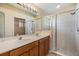 Bathroom featuring double sinks, a large mirror, vanity, and a glass-enclosed shower stall at 5205 Lansdowne Way, Palmetto, FL 34221
