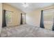Bright bedroom featuring neutral walls, vaulted ceiling, ceiling fan, three windows, and carpeted floor at 5205 Lansdowne Way, Palmetto, FL 34221