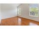 A bedroom featuring hard wood floors, two large windows, and white walls at 5205 Lansdowne Way, Palmetto, FL 34221