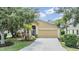 Charming single-story home with a well-maintained lawn, mature landscaping, and an attached two-car garage at 5205 Lansdowne Way, Palmetto, FL 34221