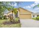Charming single-story home with a well-manicured lawn and vibrant landscaping at 5205 Lansdowne Way, Palmetto, FL 34221