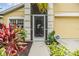 Inviting front entrance with decorative screen door and lush tropical foliage at 5205 Lansdowne Way, Palmetto, FL 34221