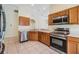 Well-lit kitchen with stainless steel appliances, tile floors, and access to the dining area at 5205 Lansdowne Way, Palmetto, FL 34221