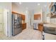 Modern kitchen features stainless steel appliances, wood cabinets, and tile flooring at 5205 Lansdowne Way, Palmetto, FL 34221