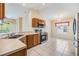Open kitchen offers stainless appliances, wood cabinets, and breakfast nook area at 5205 Lansdowne Way, Palmetto, FL 34221
