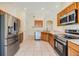 Updated kitchen with stainless steel appliances, wood cabinets, and tile flooring at 5205 Lansdowne Way, Palmetto, FL 34221