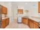 Bright kitchen features stainless steel appliances, wood cabinetry, and ample counter space at 5205 Lansdowne Way, Palmetto, FL 34221