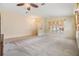 Spacious living room features neutral carpet, recessed lighting, and large window at 5205 Lansdowne Way, Palmetto, FL 34221