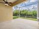 Relaxing screened-in patio with ceiling fan and view of lush greenery, perfect for outdoor enjoyment at 5205 Lansdowne Way, Palmetto, FL 34221