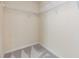 A walk-in closet featuring carpeted floor, built-in shelves, and white walls at 5205 Lansdowne Way, Palmetto, FL 34221