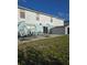 Well-maintained backyard featuring an outdoor seating area, shed, and lush green lawn at 5391 Baldock Ave, Spring Hill, FL 34608