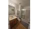Well-lit bathroom featuring a vanity with sink, toilet, and a shower with sliding glass doors at 5391 Baldock Ave, Spring Hill, FL 34608
