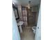Bathroom with patterned tile flooring and shower with safety bars at 5391 Baldock Ave, Spring Hill, FL 34608