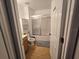 Bright bathroom features a tub-shower combo with glass doors and white vanity at 5391 Baldock Ave, Spring Hill, FL 34608