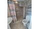 Neutral toned bathroom featuring a walk-in shower, grab bar, and tiled floor at 5391 Baldock Ave, Spring Hill, FL 34608