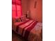Cozy bedroom with a double bed, side tables, lamp, and hardwood-style flooring at 5391 Baldock Ave, Spring Hill, FL 34608