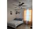 Bedroom with ceiling fan and musical decor, furnished with a double bed and matching side table at 5391 Baldock Ave, Spring Hill, FL 34608