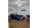 Comfortable bedroom featuring wood-look flooring, a ceiling fan, and a bed with stylish blue bedding at 5391 Baldock Ave, Spring Hill, FL 34608