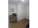 Bedroom featuring wood-look flooring, closet, and a dresser with a mirror at 5391 Baldock Ave, Spring Hill, FL 34608