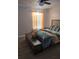 Comfortable bedroom featuring wood-look flooring, a ceiling fan, and bright curtains at 5391 Baldock Ave, Spring Hill, FL 34608