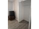 Walk-in closet with wood-look floors and ample shelving, adjacent to a mini fridge and wooden bureau at 5391 Baldock Ave, Spring Hill, FL 34608