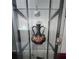 Glass display cabinet featuring an ornate vase, statues, and shelves at 5391 Baldock Ave, Spring Hill, FL 34608