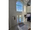 Bright foyer with decorative glass window, chandelier, tile floor, and view into the living room at 5391 Baldock Ave, Spring Hill, FL 34608