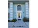 Charming two-story home featuring a unique blue exterior, arched window, and well-maintained landscaping at 5391 Baldock Ave, Spring Hill, FL 34608