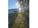 The front yard offers a glimpse of the home with its blue facade and lush green surroundings at 5391 Baldock Ave, Spring Hill, FL 34608