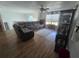 Comfortable living room with a large sectional sofa, ceiling fan, and natural light from the window at 5391 Baldock Ave, Spring Hill, FL 34608