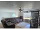 Comfortable living room with a plush gray sofa, ceiling fan, and window with blinds at 5391 Baldock Ave, Spring Hill, FL 34608