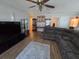 Spacious living room featuring hardwood floors, a large sectional sofa, and stylish decor at 5391 Baldock Ave, Spring Hill, FL 34608