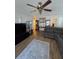 Comfortable living room featuring hardwood floors, a ceiling fan, and cozy furniture at 5391 Baldock Ave, Spring Hill, FL 34608