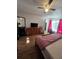 Bedroom featuring wood-look floors, a ceiling fan, and a large dresser with a TV on top at 5391 Baldock Ave, Spring Hill, FL 34608