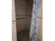 Standing shower features tile surround, showerhead, grab bar and decorative shower curtain at 5391 Baldock Ave, Spring Hill, FL 34608