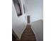 A carpeted staircase with white walls, arches, and a unique wall decoration at 5391 Baldock Ave, Spring Hill, FL 34608