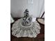 Table featuring an art deco statue displayed on a handmade, crocheted doily at 5391 Baldock Ave, Spring Hill, FL 34608