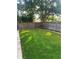 Lush green backyard featuring well-manicured artificial turf and a wood fence for privacy at 5645 97Th N Way, St Petersburg, FL 33708